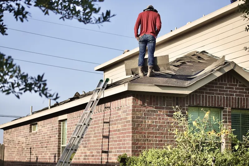 Professional roofer working on a residential roof in Mattapoisett